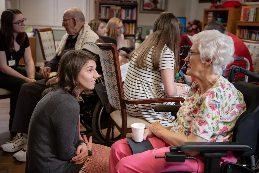 Student with AU GIVS visits with a resident of Good Shepherd nursing home